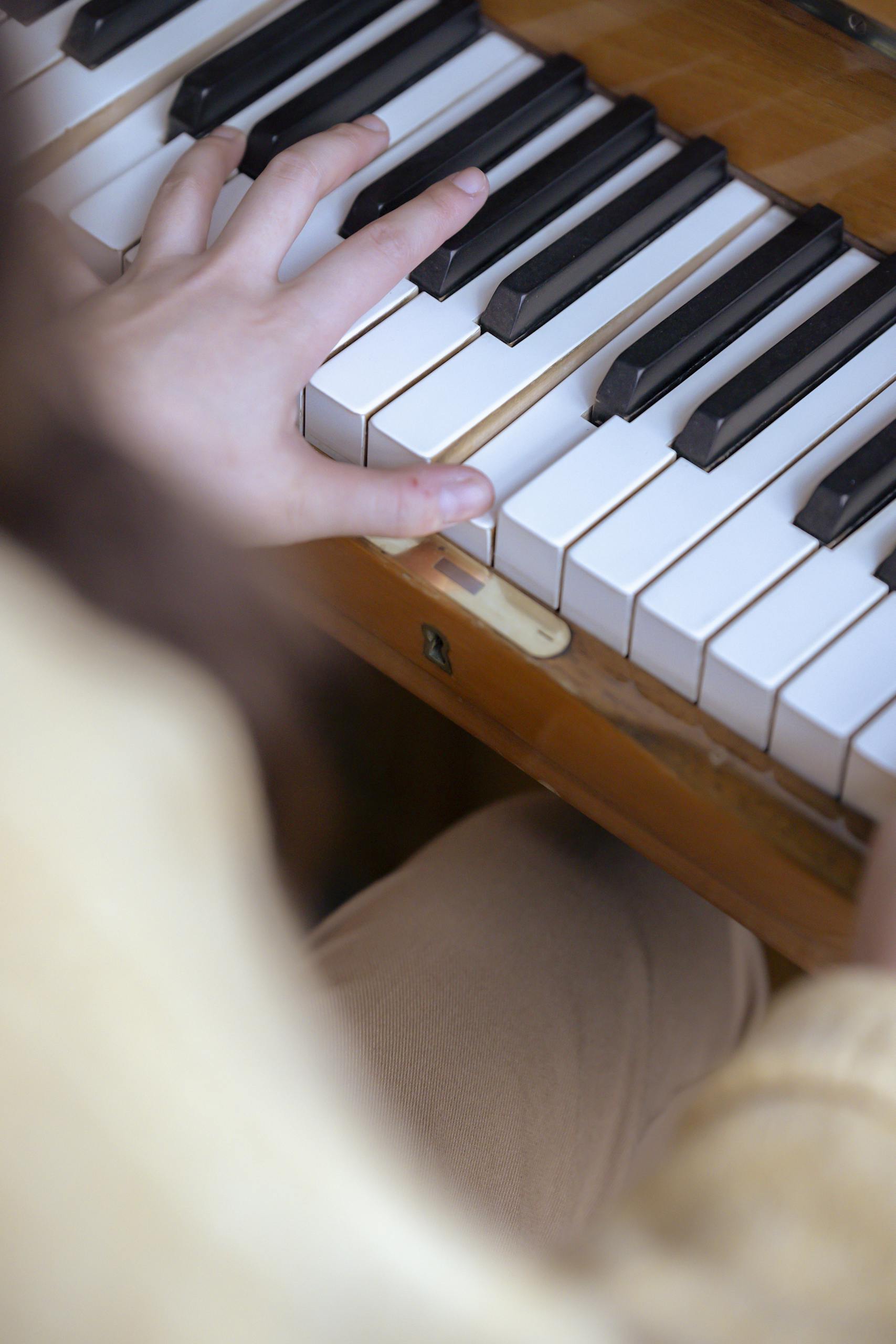 A focused view of hands on a piano keyboard illustrating musical practice and skill.